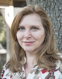 A woman with long hair and blue eyes.